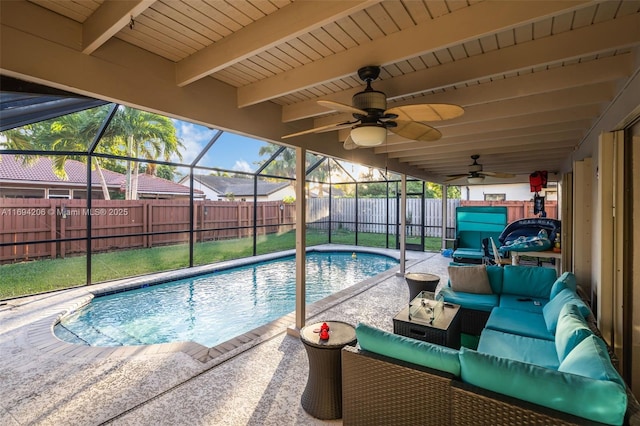view of pool with glass enclosure, a patio, and a fenced backyard