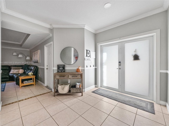 foyer featuring light tile patterned floors and ornamental molding