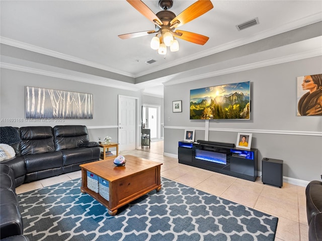 tiled living room featuring ceiling fan and ornamental molding