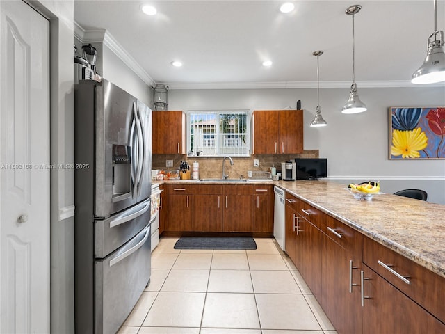 kitchen with pendant lighting, stainless steel appliances, ornamental molding, and sink