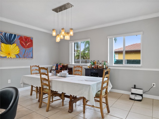 dining area featuring light tile patterned floors, ornamental molding, and an inviting chandelier