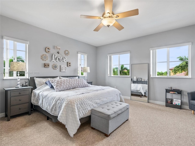 bedroom featuring ceiling fan and light carpet