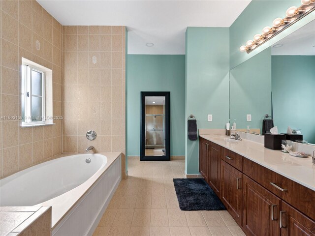 bathroom featuring vanity, tile patterned floors, and a bathtub