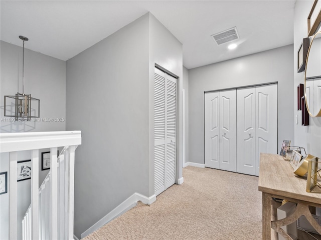 corridor with light colored carpet