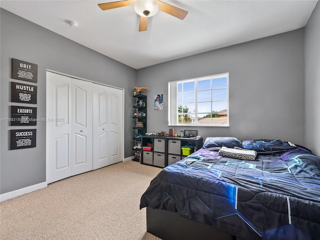 bedroom with ceiling fan, a closet, and carpet floors