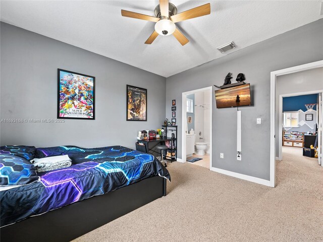 carpeted bedroom with ceiling fan and connected bathroom