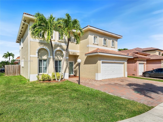 mediterranean / spanish-style home featuring a front yard and a garage