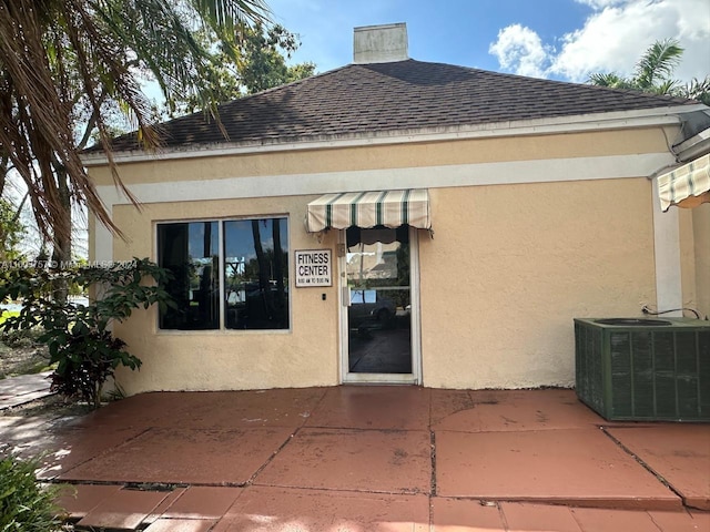 back of property featuring central AC unit and a patio area