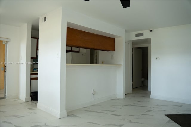 unfurnished room with visible vents, marble finish floor, and baseboards