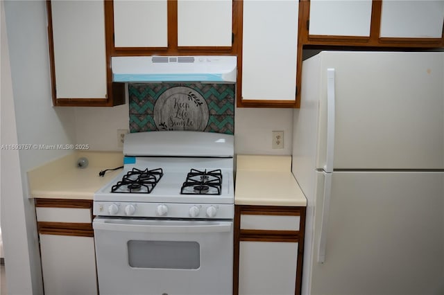 kitchen featuring under cabinet range hood, tasteful backsplash, white appliances, white cabinets, and light countertops