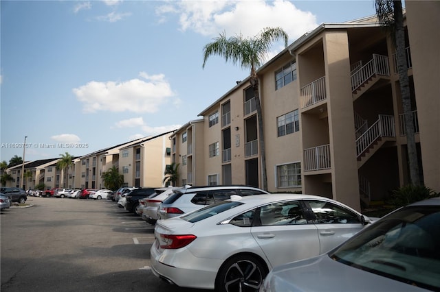 view of building exterior featuring uncovered parking