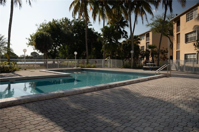 pool featuring a patio and fence