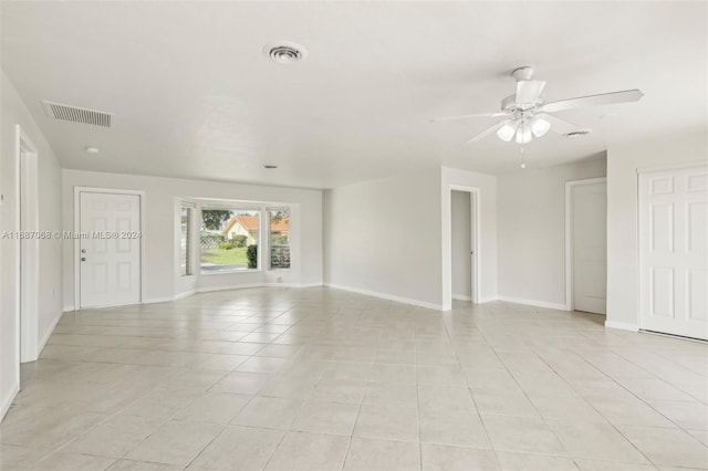 spare room featuring ceiling fan and light tile patterned flooring