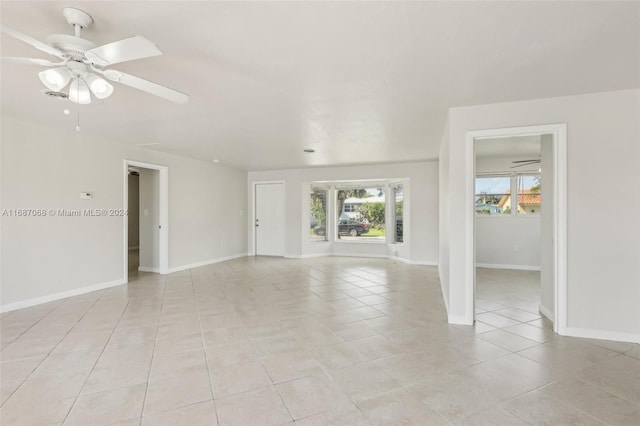 tiled empty room with ceiling fan