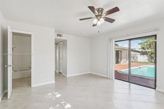 tiled spare room featuring ceiling fan