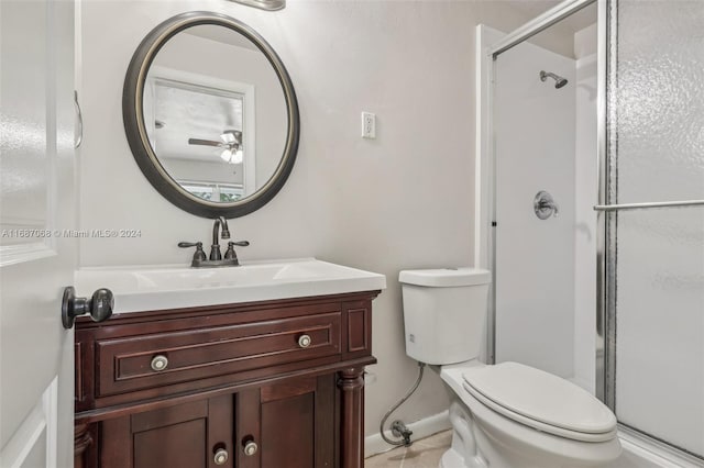 bathroom with vanity, toilet, and a shower with door