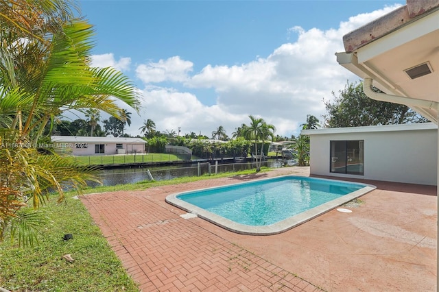 view of pool featuring a patio area and a water view