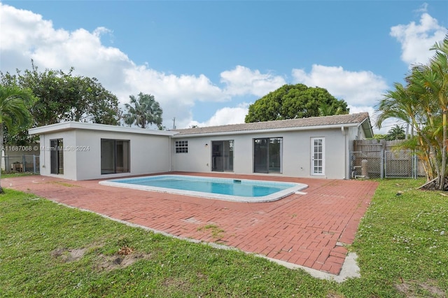 view of swimming pool with a patio area and a lawn