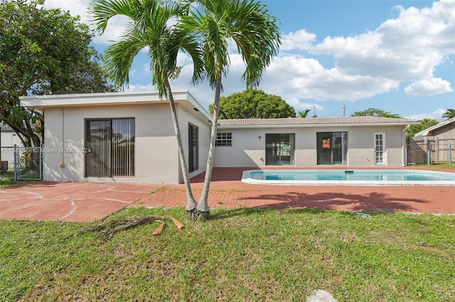 back of house with a patio area, a yard, and a fenced in pool