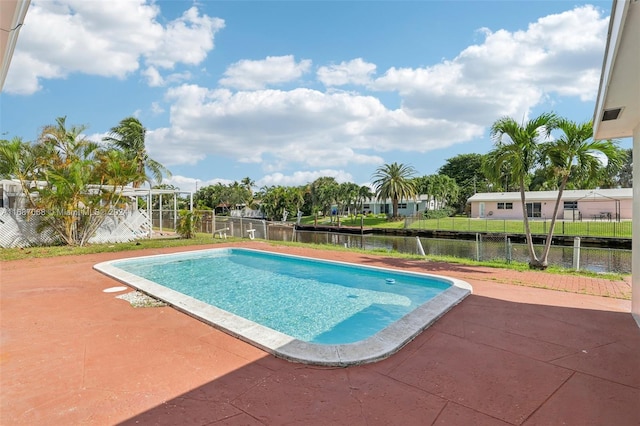 view of swimming pool featuring a water view and a patio