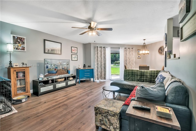 living room with a textured ceiling, wood-type flooring, and ceiling fan with notable chandelier