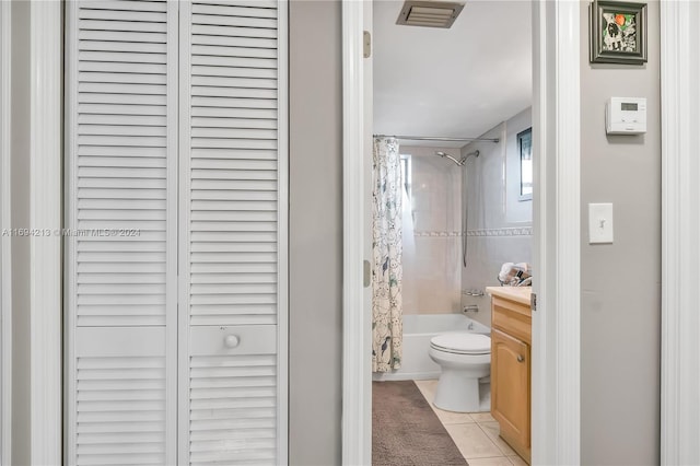 full bathroom featuring tile patterned flooring, shower / bath combo, vanity, and toilet