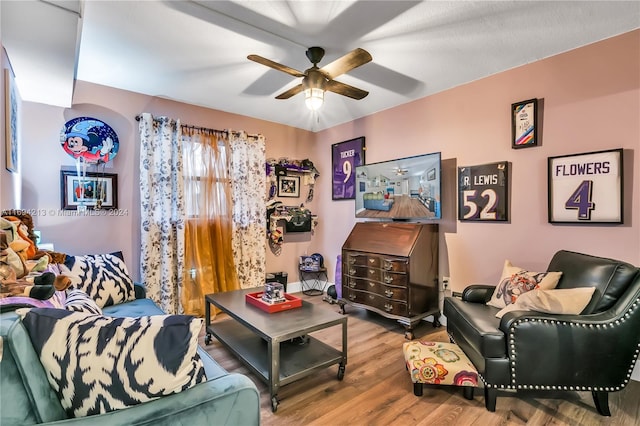 living room with ceiling fan and light wood-type flooring