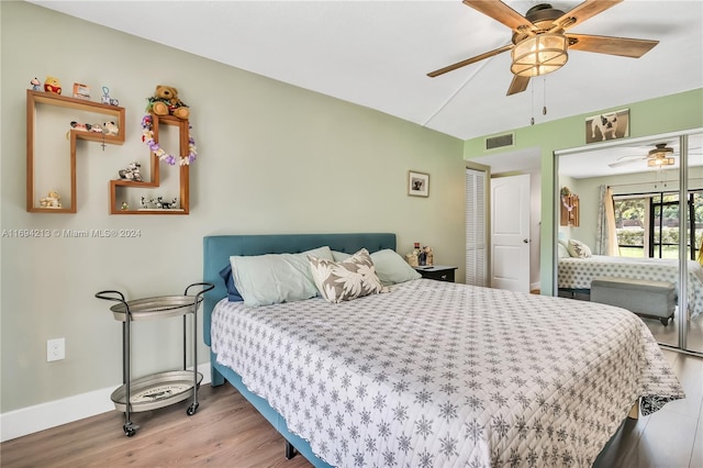 bedroom featuring ceiling fan, a closet, and light hardwood / wood-style flooring