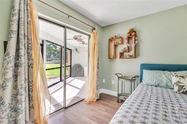 bedroom featuring access to exterior and light wood-type flooring