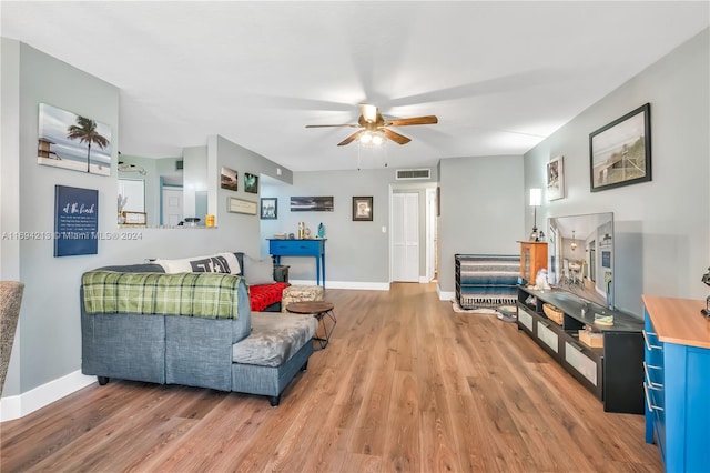 living room featuring ceiling fan and wood-type flooring