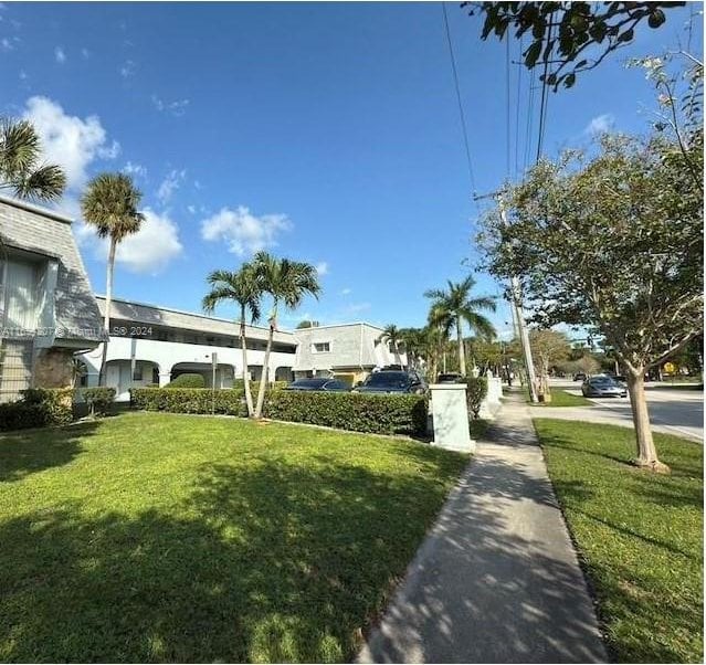 view of property's community featuring a yard