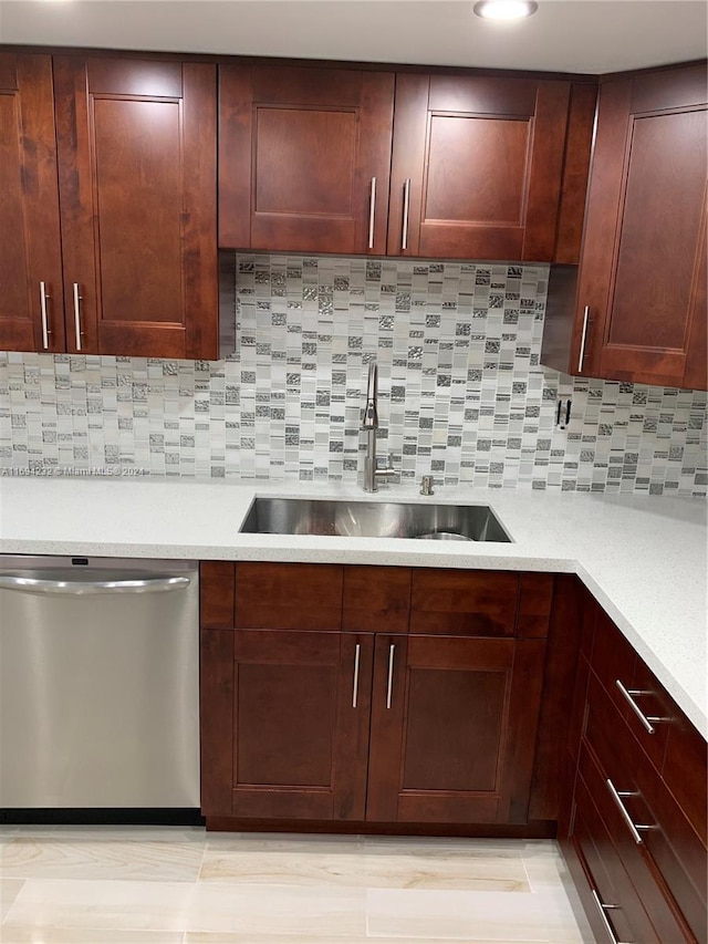 kitchen with decorative backsplash, dishwasher, and sink