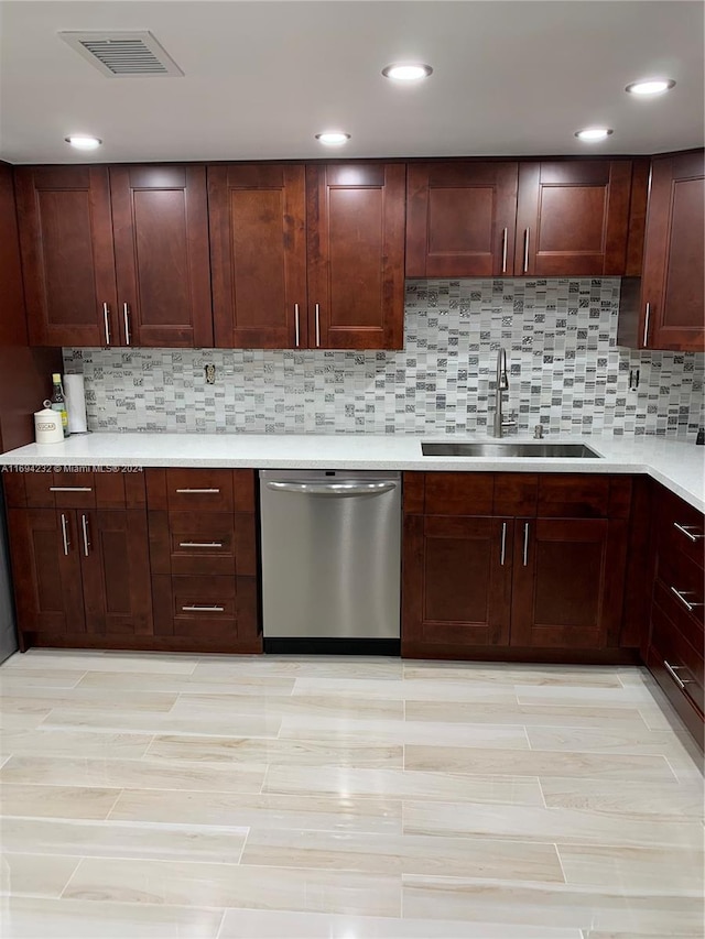 kitchen with tasteful backsplash, dishwasher, and sink