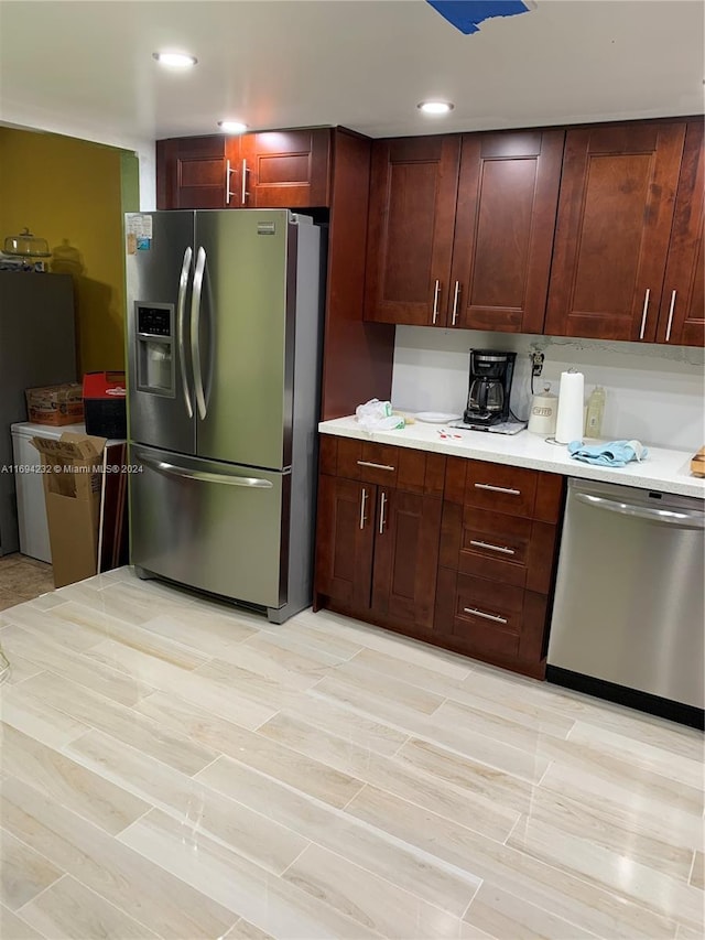 kitchen with light wood-type flooring and appliances with stainless steel finishes