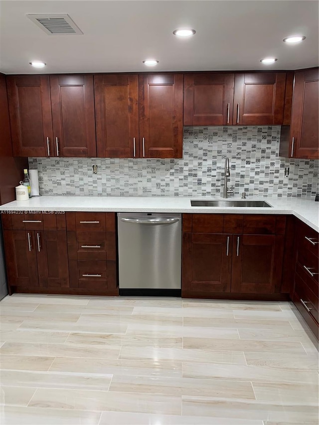 kitchen featuring a sink, visible vents, light countertops, decorative backsplash, and dishwasher