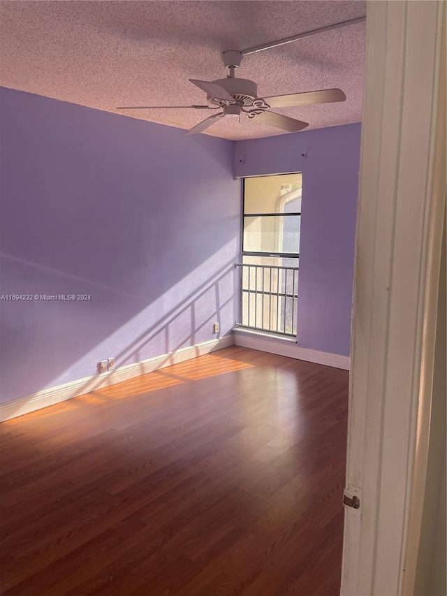 unfurnished room with wood-type flooring, a textured ceiling, and ceiling fan