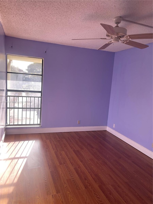 spare room with ceiling fan, wood-type flooring, and a textured ceiling