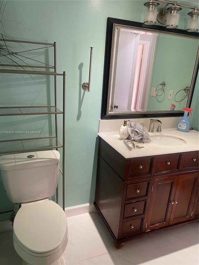 bathroom with tile patterned floors, vanity, and toilet