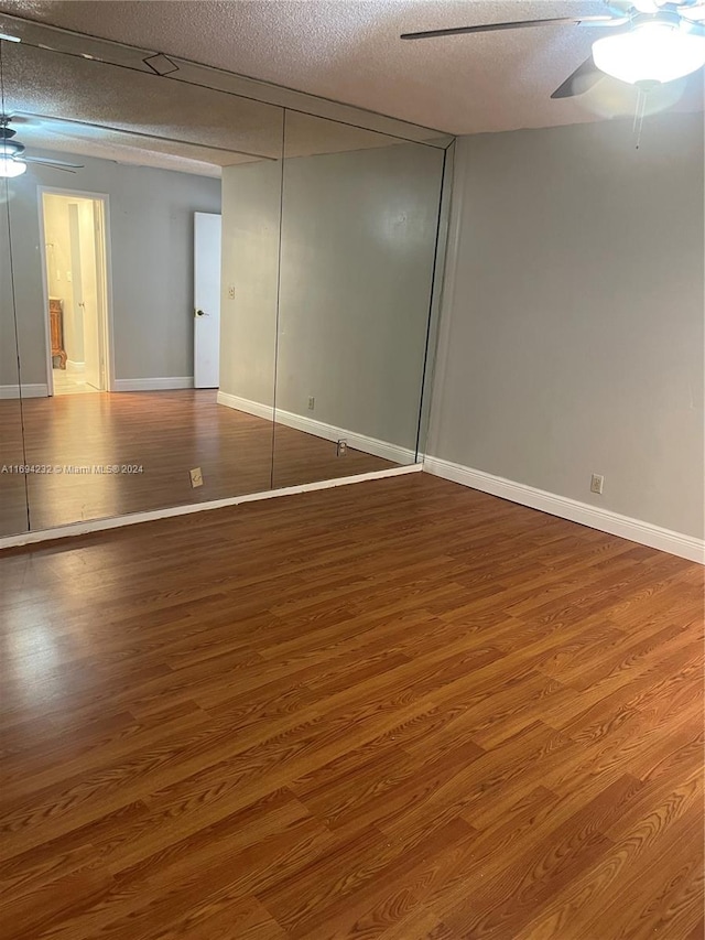 interior space with wood-type flooring and a textured ceiling