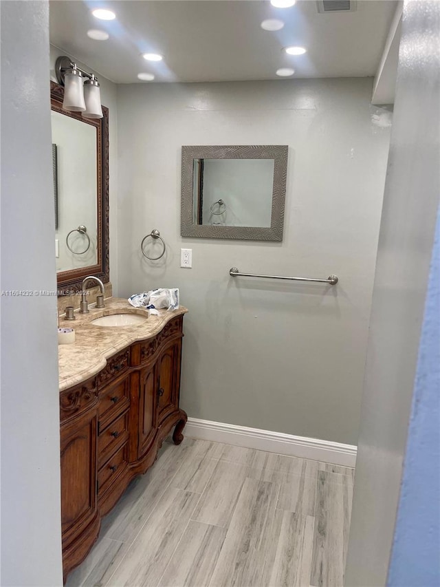 bathroom with vanity and hardwood / wood-style flooring