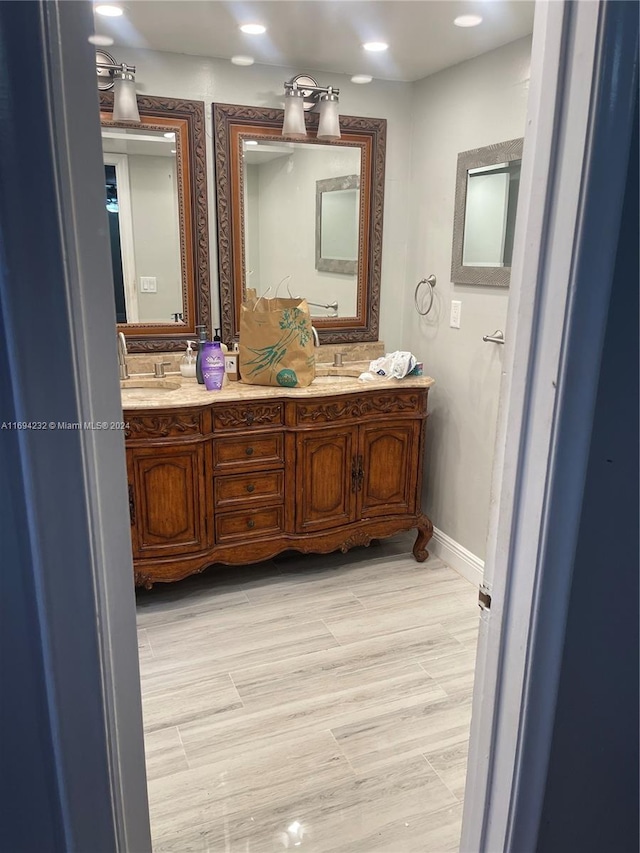 bathroom with hardwood / wood-style floors and vanity