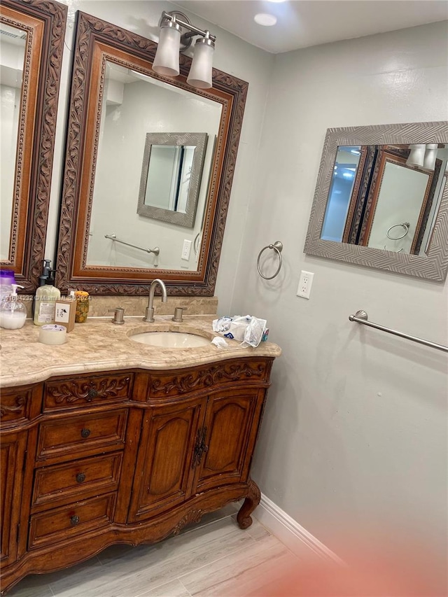 bathroom with vanity and hardwood / wood-style flooring