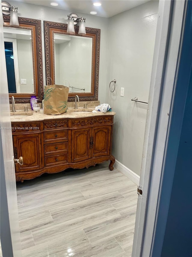 bathroom featuring hardwood / wood-style floors and vanity