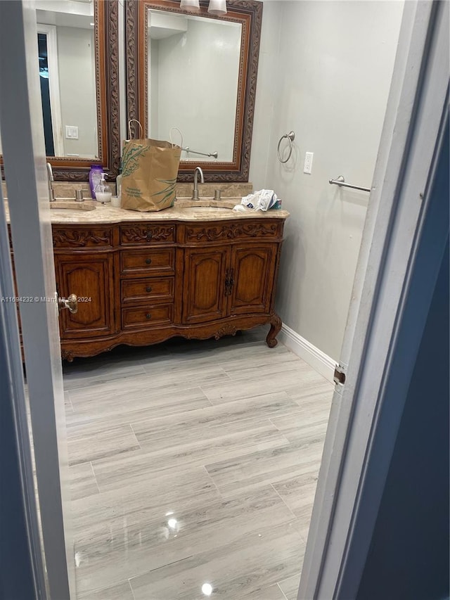 bathroom with hardwood / wood-style floors and vanity