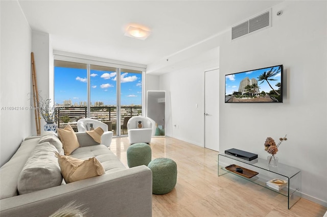 living room with floor to ceiling windows and light wood-type flooring