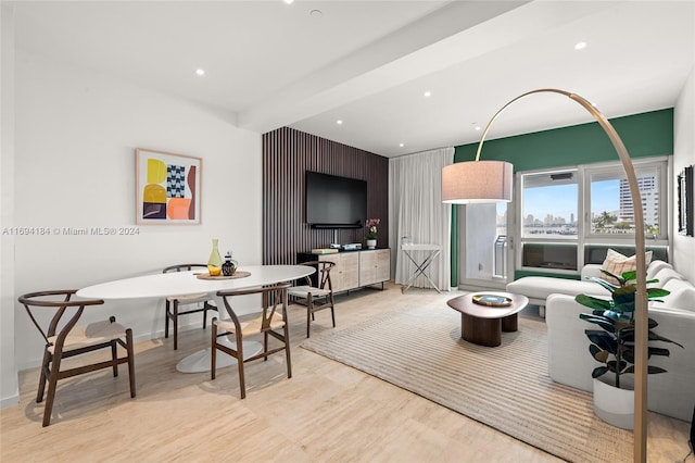 living room with beam ceiling and light wood-type flooring