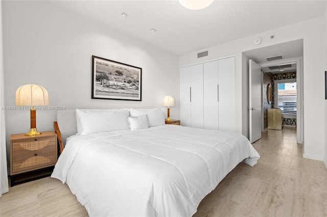 bedroom featuring light hardwood / wood-style floors and a closet