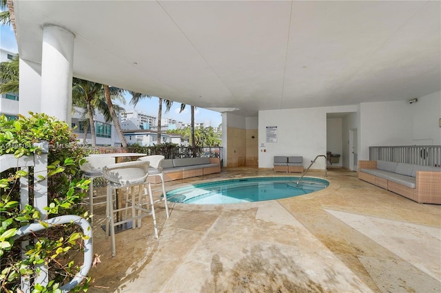 view of pool with outdoor lounge area and a patio