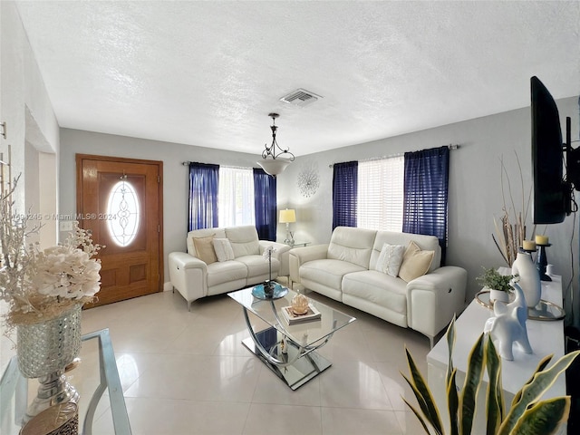 living room with light tile patterned floors and a textured ceiling