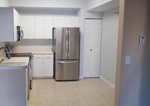 kitchen with white cabinets and appliances with stainless steel finishes